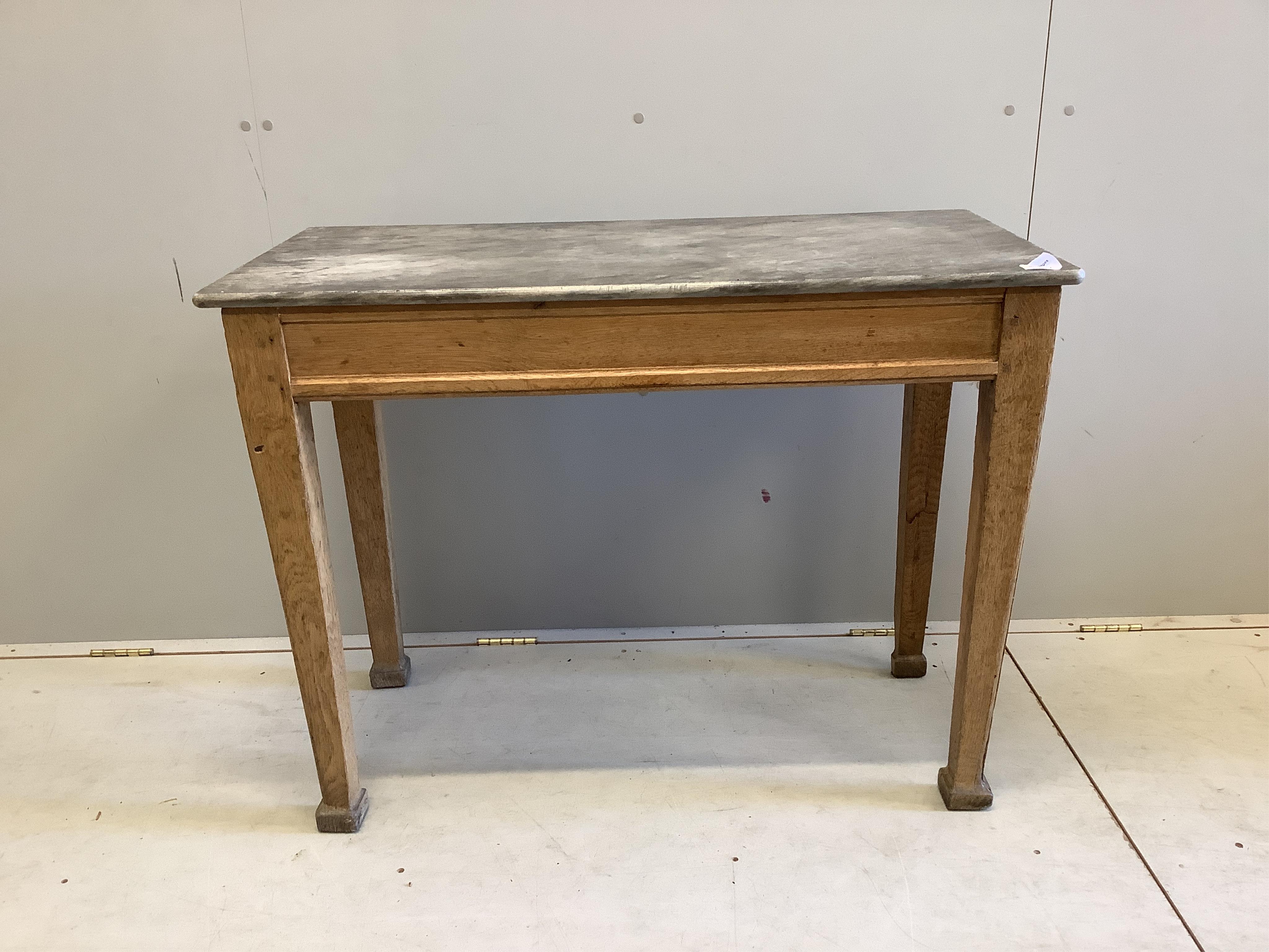 An early 20th century rectangular marble topped oak table, width 100cm, depth 49cm, height 75cm. Condition - poor to fair